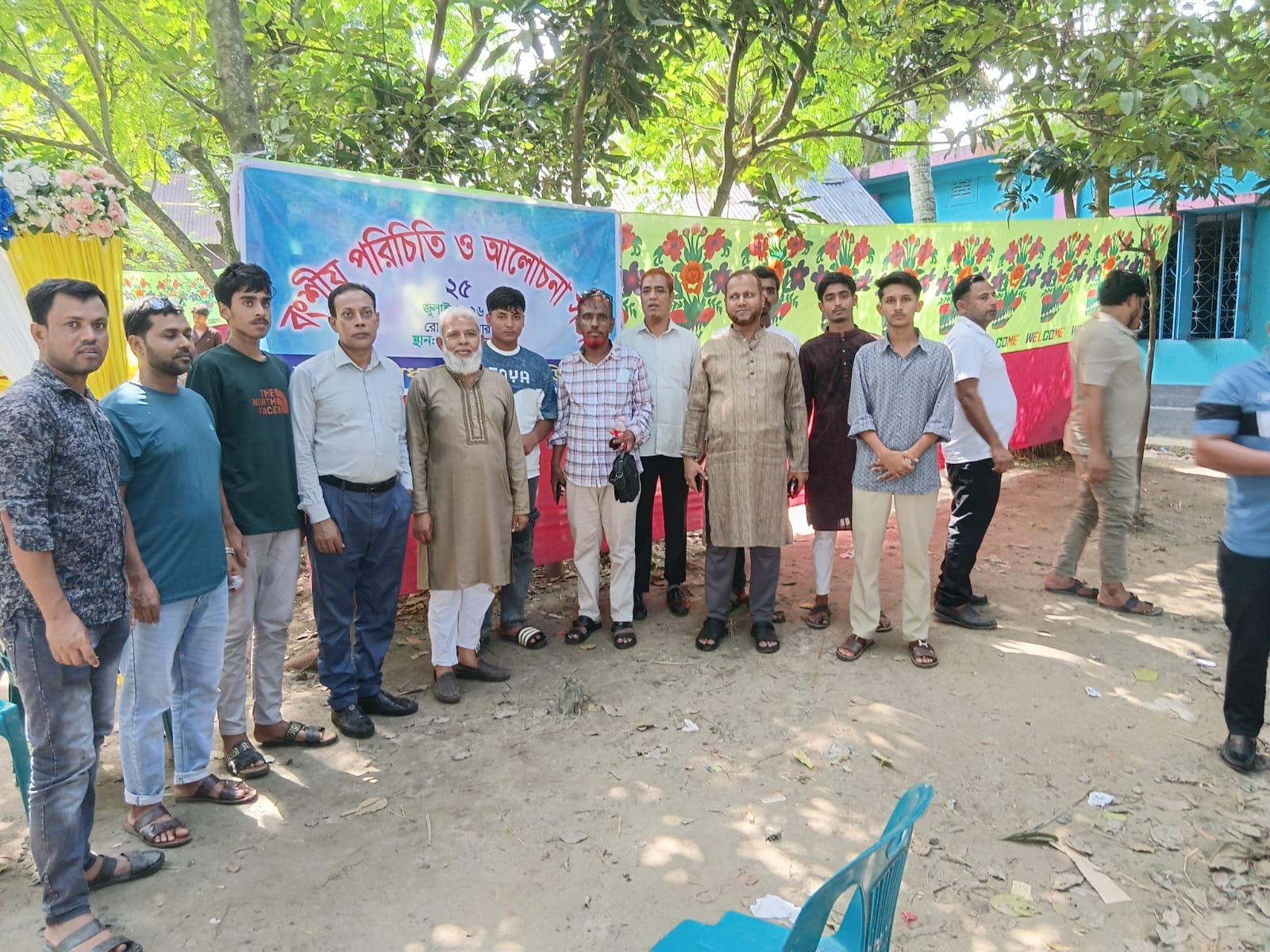 Group of men at an event with a banner.